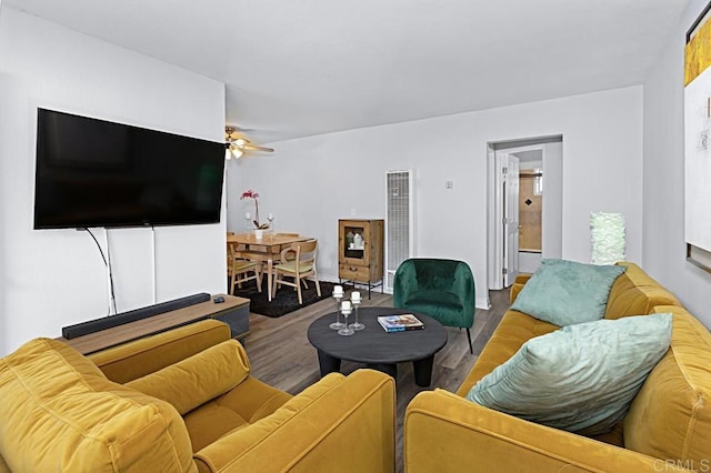 living room featuring hardwood / wood-style floors and ceiling fan