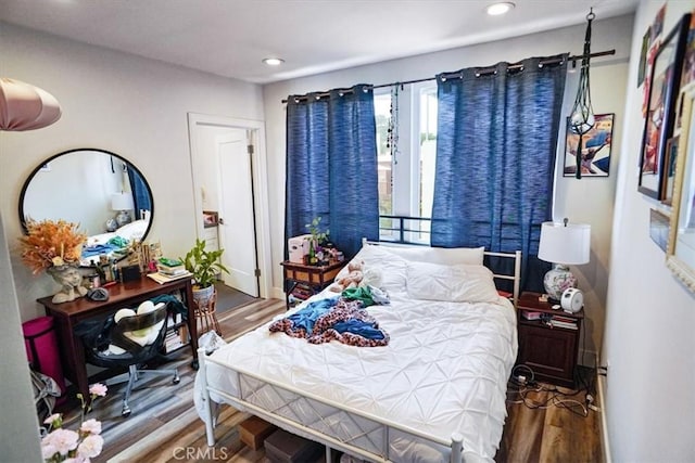 bedroom with hardwood / wood-style flooring