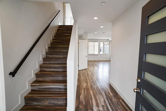 stairway with hardwood / wood-style flooring