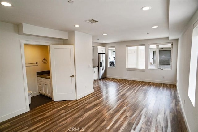 unfurnished living room featuring dark hardwood / wood-style floors