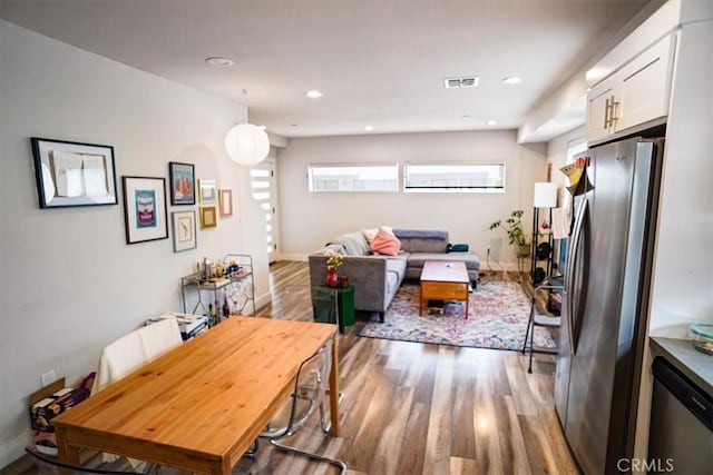 dining space with light hardwood / wood-style floors