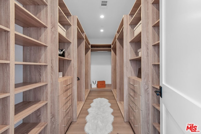 walk in closet featuring light hardwood / wood-style floors