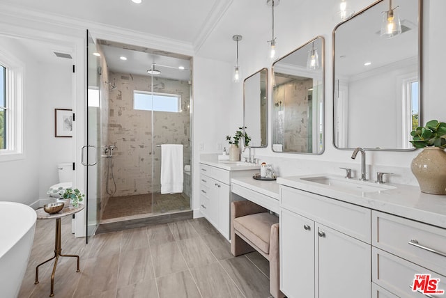 bathroom featuring vanity, crown molding, and shower with separate bathtub