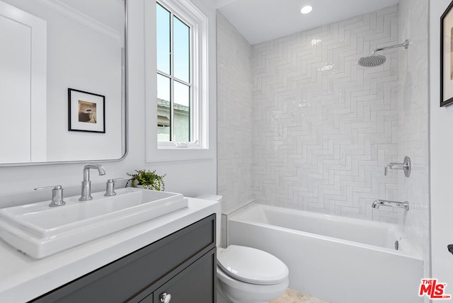 full bathroom featuring vanity, ornamental molding, tiled shower / bath, and toilet