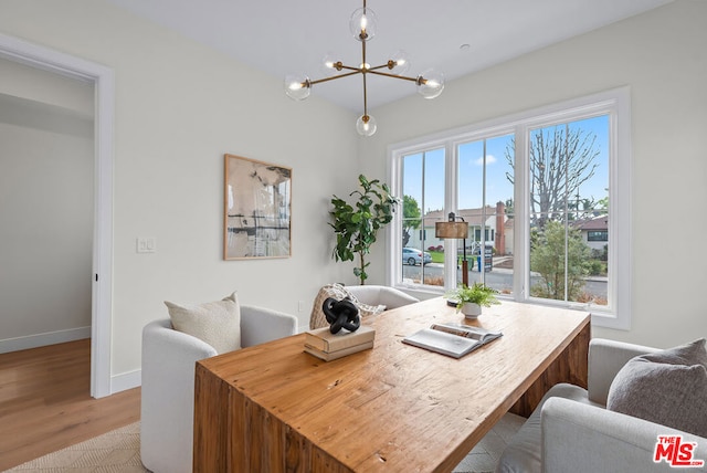 dining area with a chandelier and light hardwood / wood-style flooring