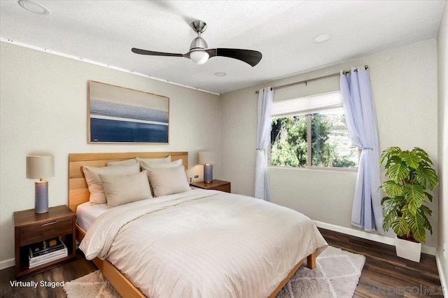 bedroom with ceiling fan and dark hardwood / wood-style flooring