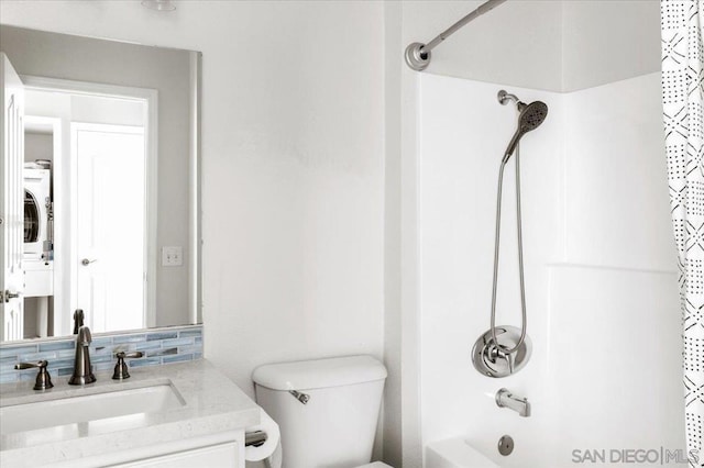 full bathroom featuring stacked washing maching and dryer, vanity, shower / bath combination with curtain, decorative backsplash, and toilet