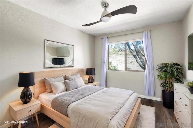 bedroom with ceiling fan and dark hardwood / wood-style flooring