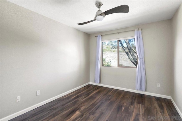 empty room featuring ceiling fan and dark hardwood / wood-style flooring