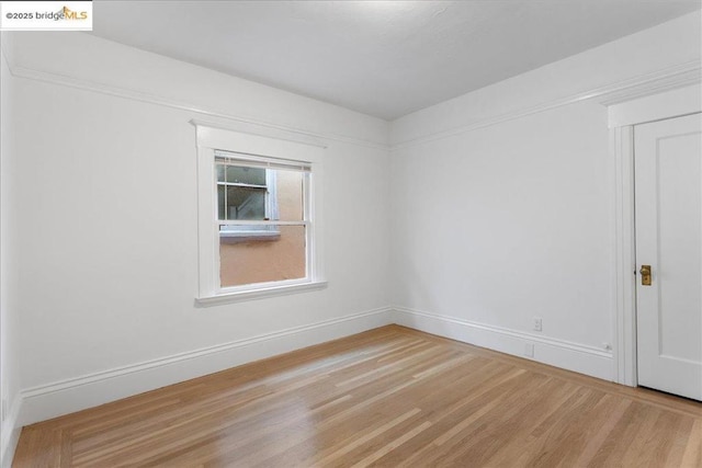 unfurnished room with wood-type flooring