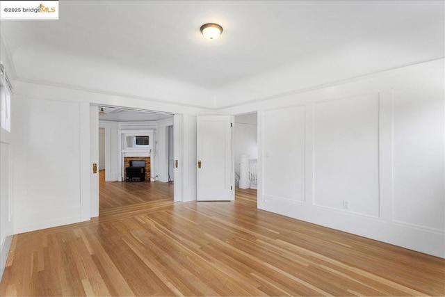 unfurnished living room with light hardwood / wood-style flooring