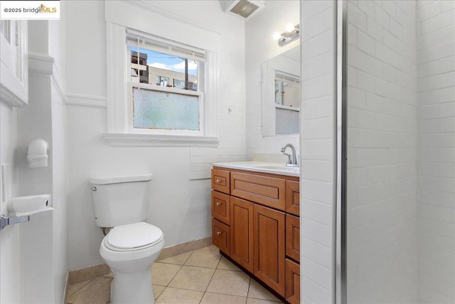 bathroom featuring tile patterned flooring, vanity, and toilet