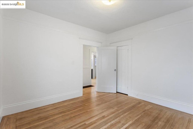 spare room with hardwood / wood-style flooring