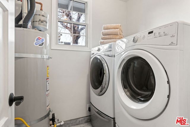 washroom with secured water heater and washer and dryer