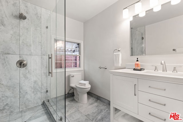 bathroom with a shower with door, vanity, and toilet