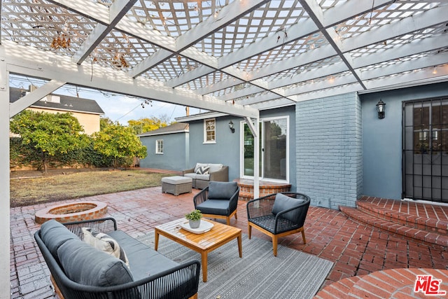 view of patio / terrace with a pergola and an outdoor living space with a fire pit