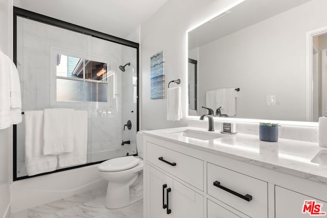 full bathroom with bath / shower combo with glass door, vanity, and toilet