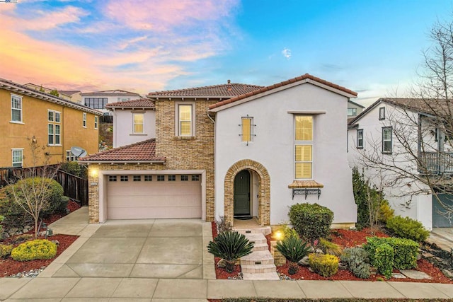 mediterranean / spanish-style home with a garage