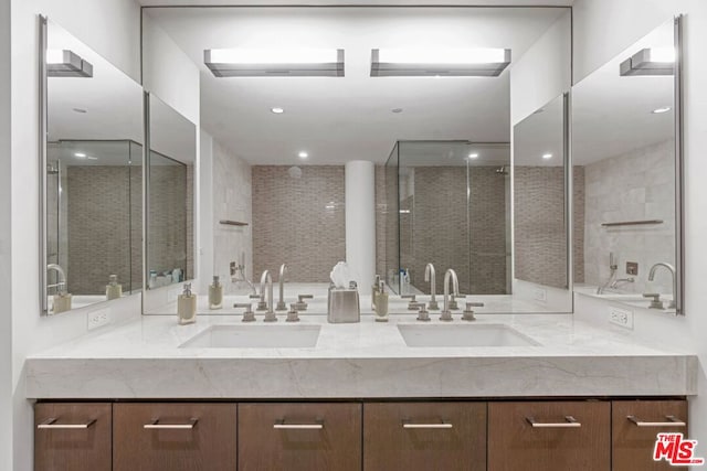 bathroom with vanity and a shower with shower door