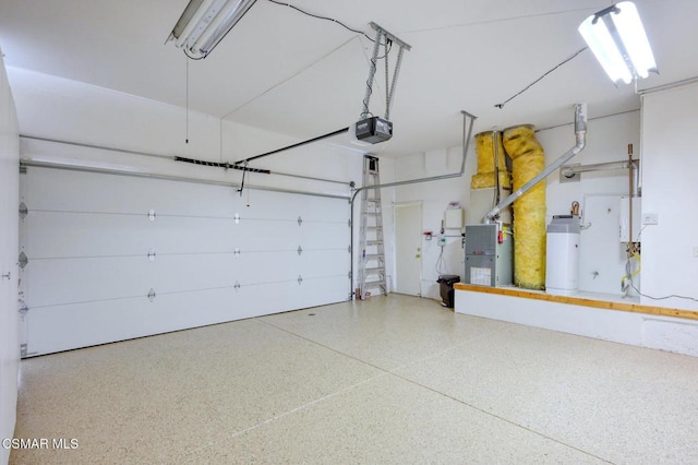 garage featuring heating unit and a garage door opener