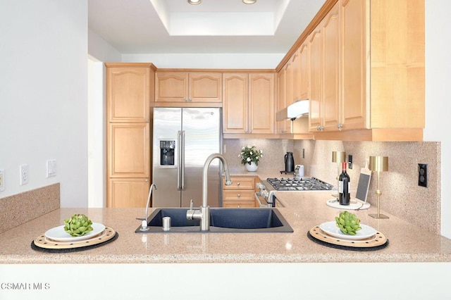 kitchen with light brown cabinetry, sink, stainless steel appliances, and light stone countertops