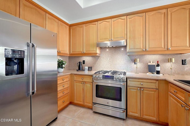 kitchen with backsplash, appliances with stainless steel finishes, and light tile patterned floors