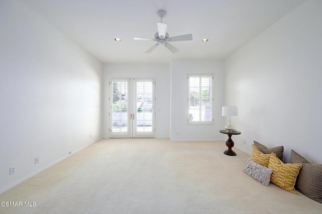 unfurnished room featuring ceiling fan and light colored carpet