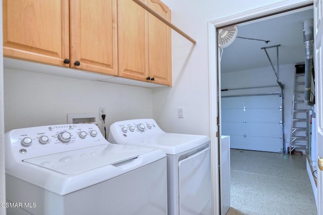 laundry room with cabinets and washer and clothes dryer