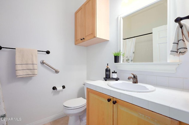 bathroom with vanity, toilet, and tile patterned flooring