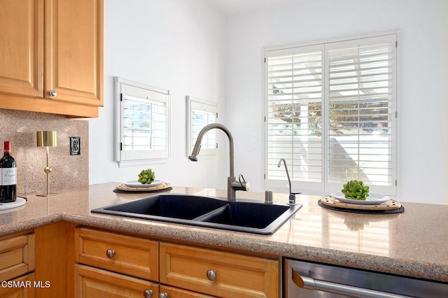 kitchen with sink, backsplash, a wealth of natural light, and stainless steel dishwasher