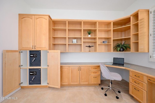 home office with light tile patterned flooring and built in desk