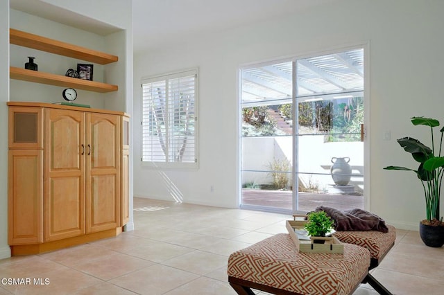 doorway to outside featuring light tile patterned flooring