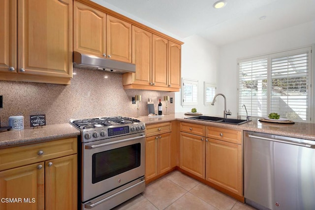 kitchen with light tile patterned flooring, appliances with stainless steel finishes, sink, and decorative backsplash