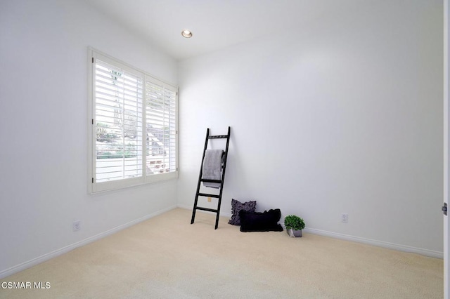 unfurnished room featuring light carpet