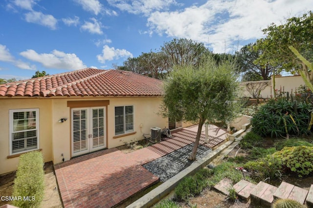 back of house featuring a patio, central AC, and french doors