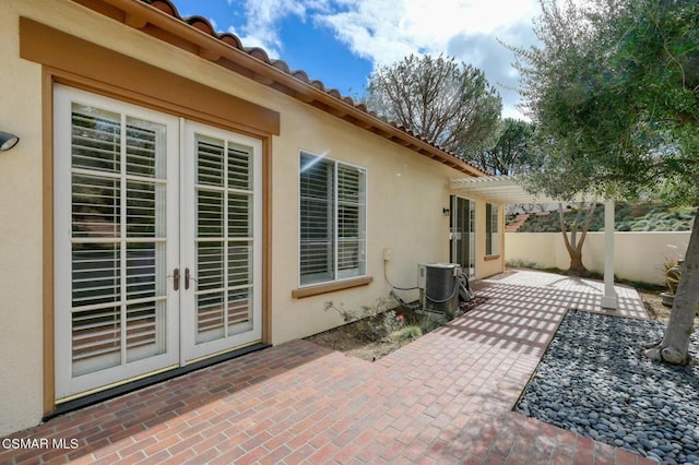 view of patio / terrace featuring french doors, central AC, and a pergola