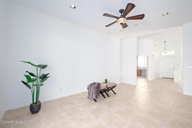 unfurnished room with light tile patterned floors and ceiling fan