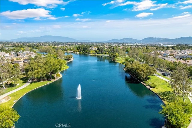 drone / aerial view featuring a water and mountain view