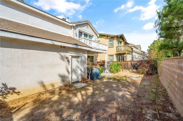 rear view of property with a balcony