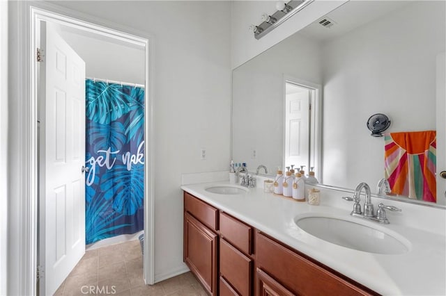 bathroom featuring tile patterned flooring and vanity