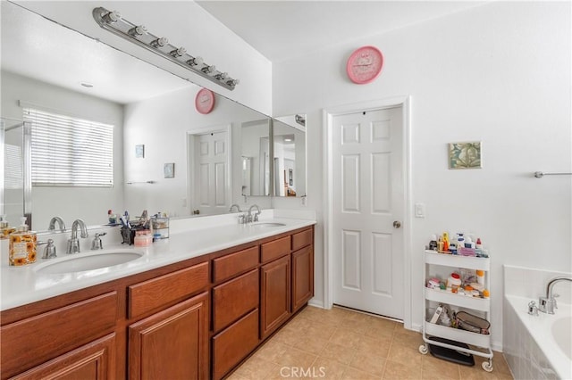 bathroom with vanity and tiled tub