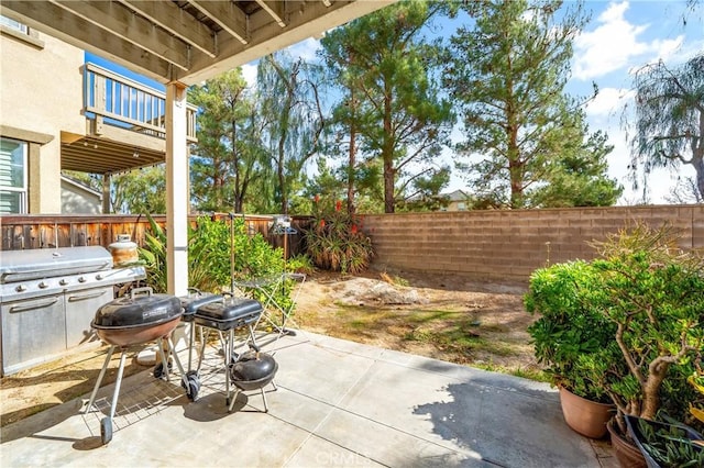 view of patio / terrace featuring a balcony and a grill