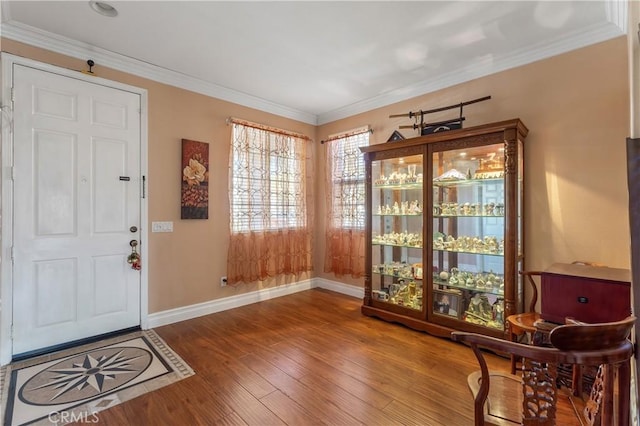 entrance foyer featuring hardwood / wood-style flooring and ornamental molding