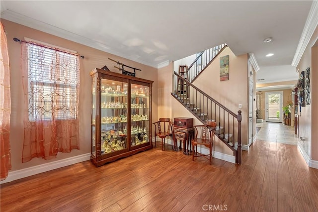 interior space featuring hardwood / wood-style flooring and ornamental molding