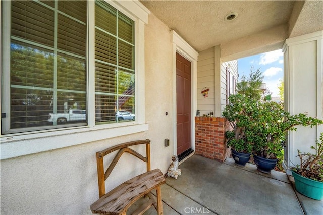 view of exterior entry featuring a porch