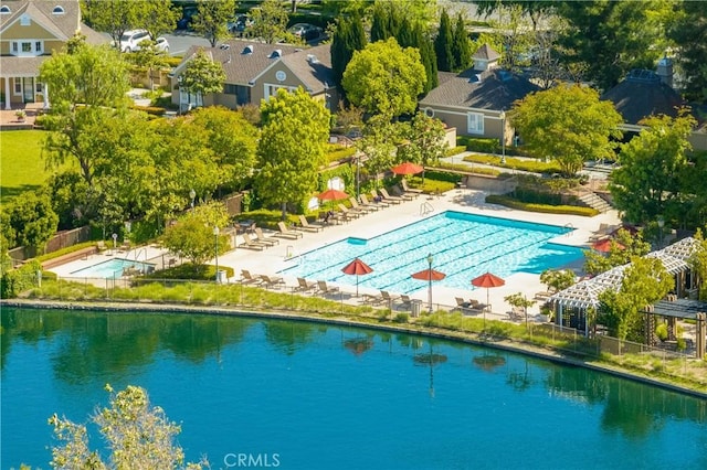 view of swimming pool featuring a water view and a pergola