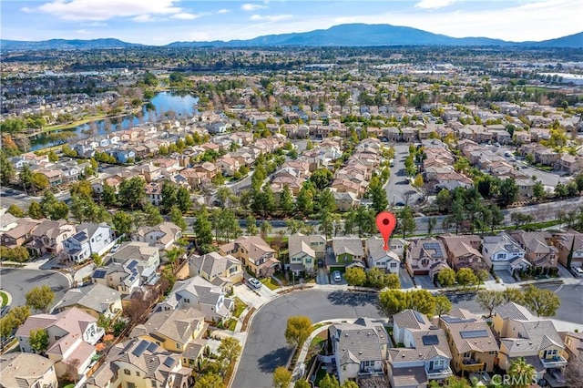 drone / aerial view with a water and mountain view