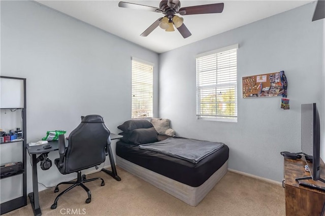 bedroom featuring light carpet and ceiling fan