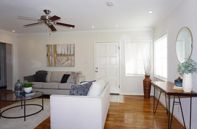 living room featuring ornamental molding, hardwood / wood-style floors, and ceiling fan