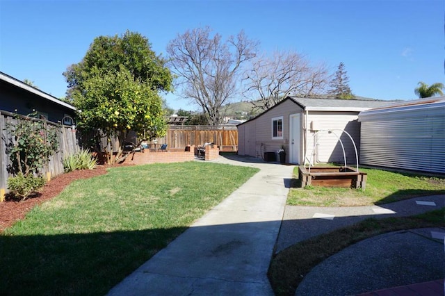 view of yard featuring a patio and an outbuilding